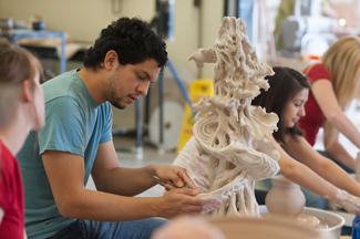 Student working on a large sculpture