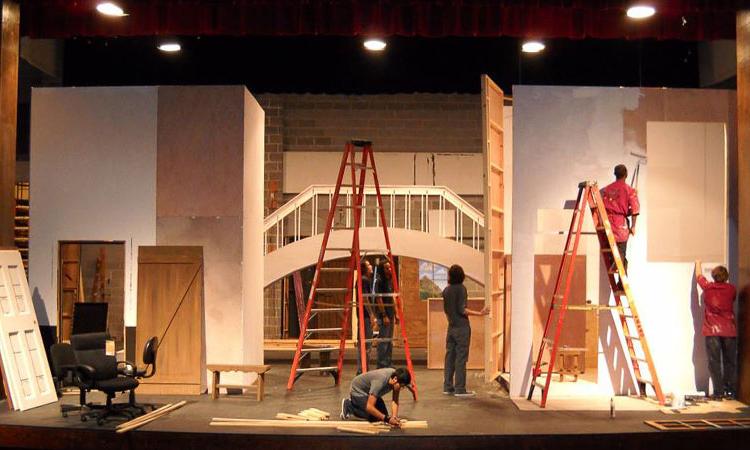 Students working on construction and paint crews