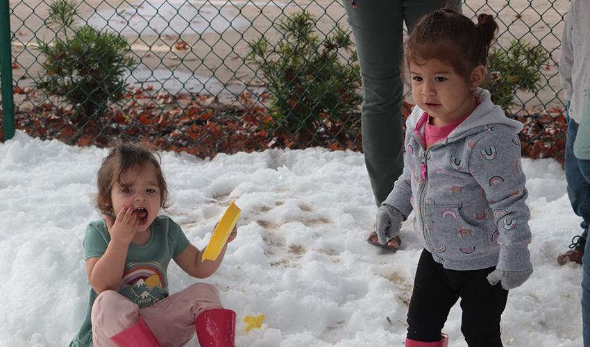 Two girls playing with the snow