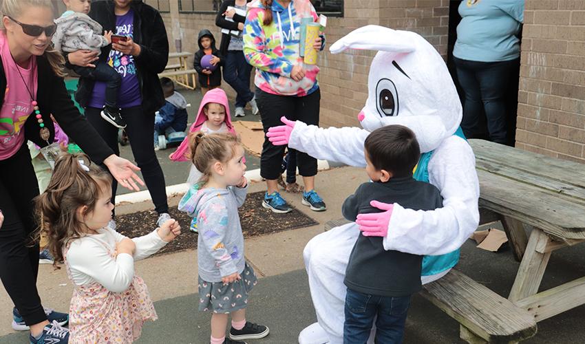 Kids getting ready to hug Mr. Bunny.