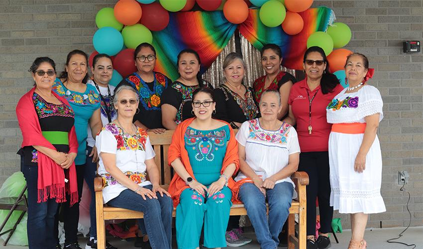 Custodian staff dressed in traditional Mexican colorful outfits. 
