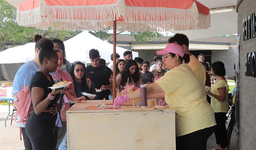 Students in line to get their traditional Mexican corn in a cup. 
