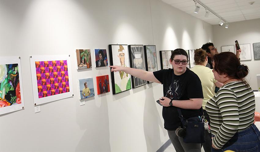 Couple of students admiring the colorful art.