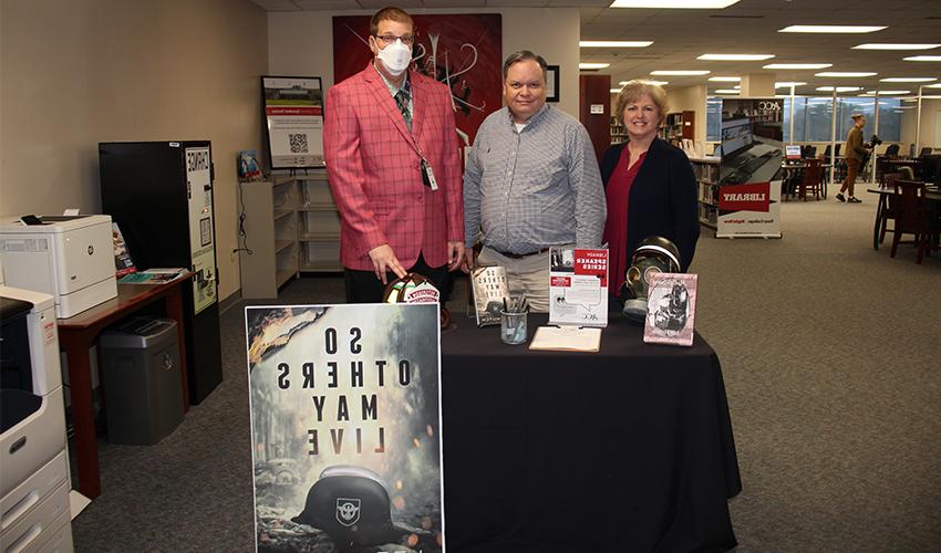 Picture of Brady Hutchison with the library staff.