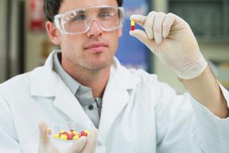 Pharmacy Technician holding a pill